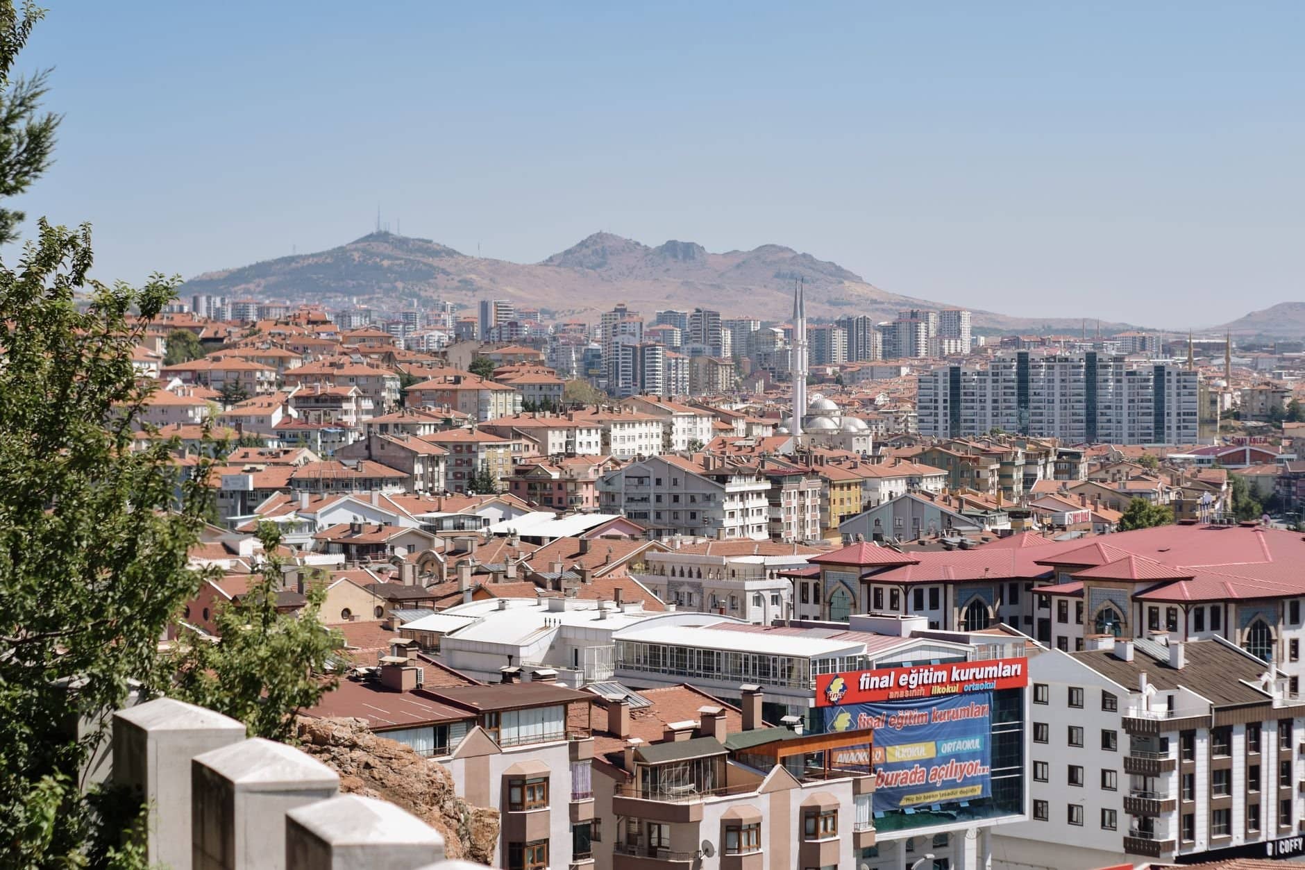 Discover Ankara's vibrant cityscape with diverse residential architecture and hill backdrop.
