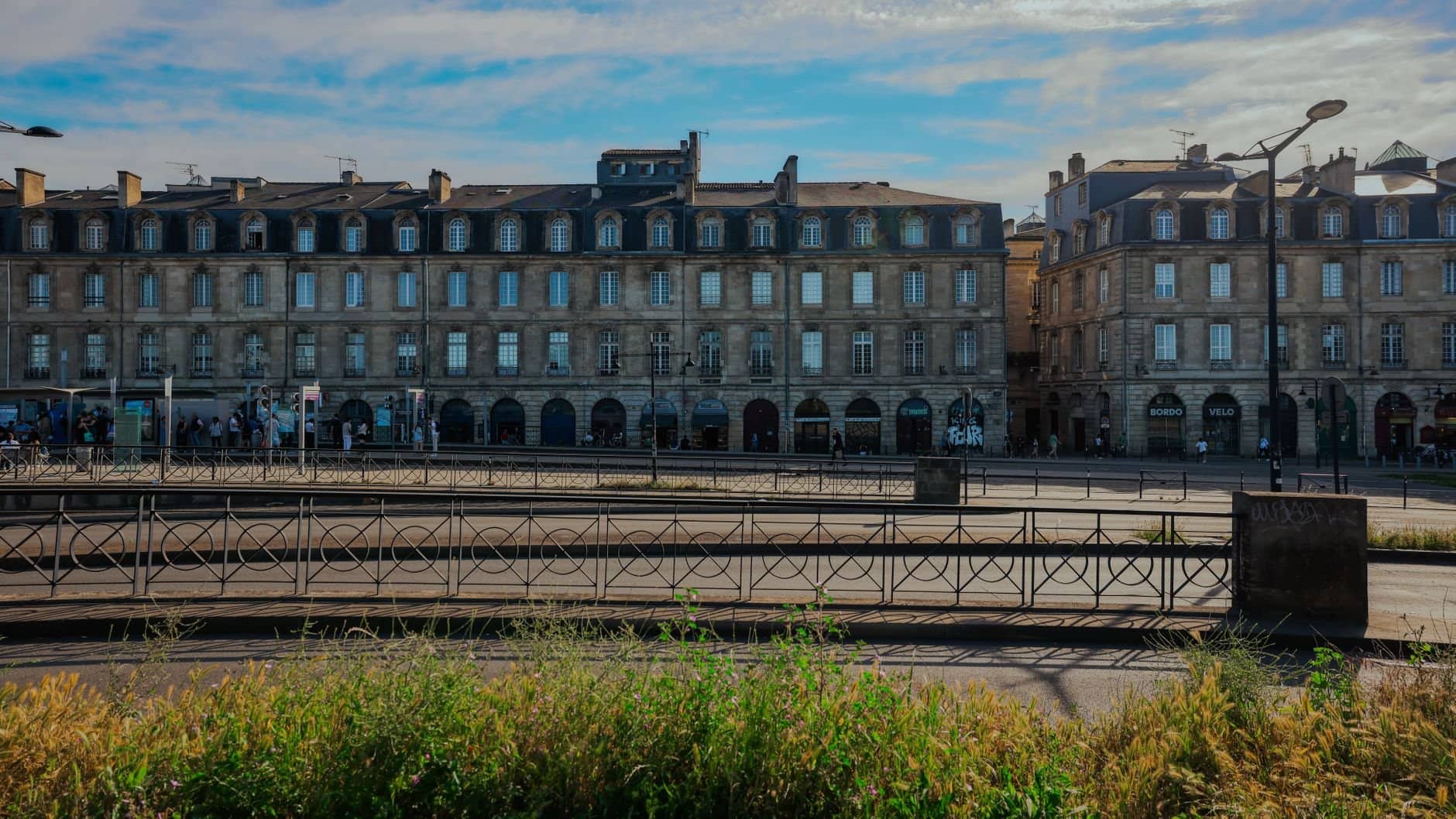 Elegant historic buildings in Bordeaux, France under a clear blue sky.