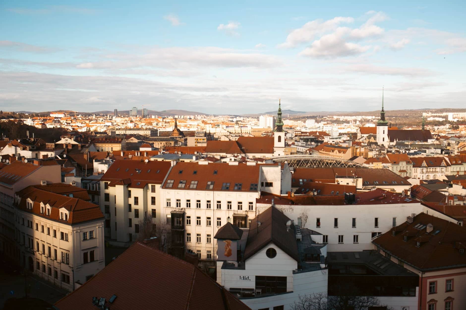 Scenic aerial view of Brno showcasing its historic central European architecture under a clear sky.
