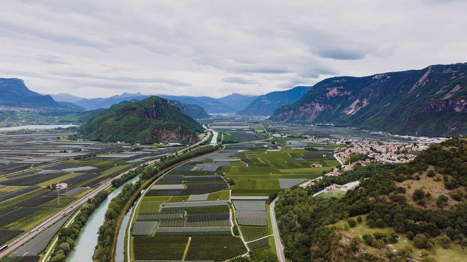 Stunning aerial view of verdant fields and mountains in the Italian countryside.