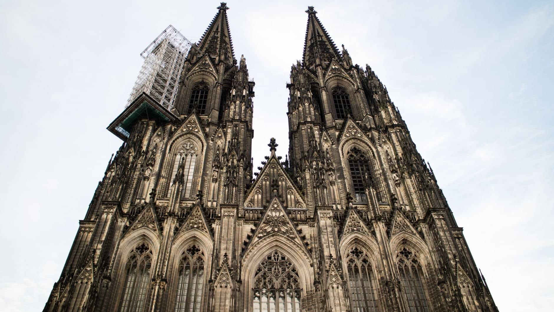 Stunning Gothic architecture of Cologne Cathedral in Germany against a clear sky.