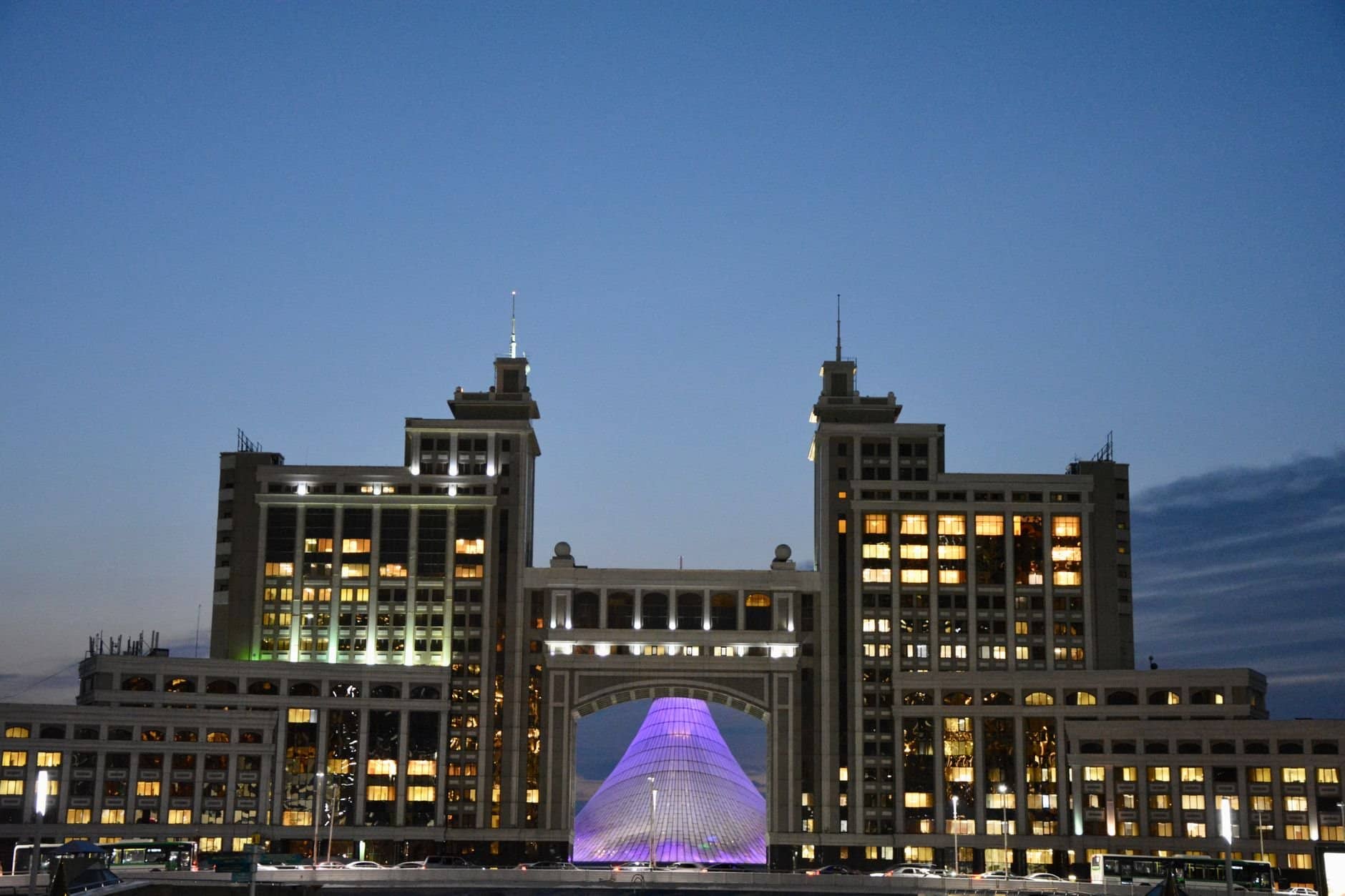 Majestic view of Astana's iconic architecture glowing against evening sky.