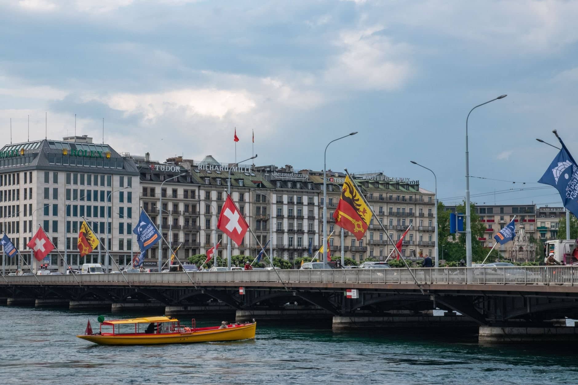 Capture of Mont-Blanc Bridge with flags and cityscape in Geneva, Switzerland.