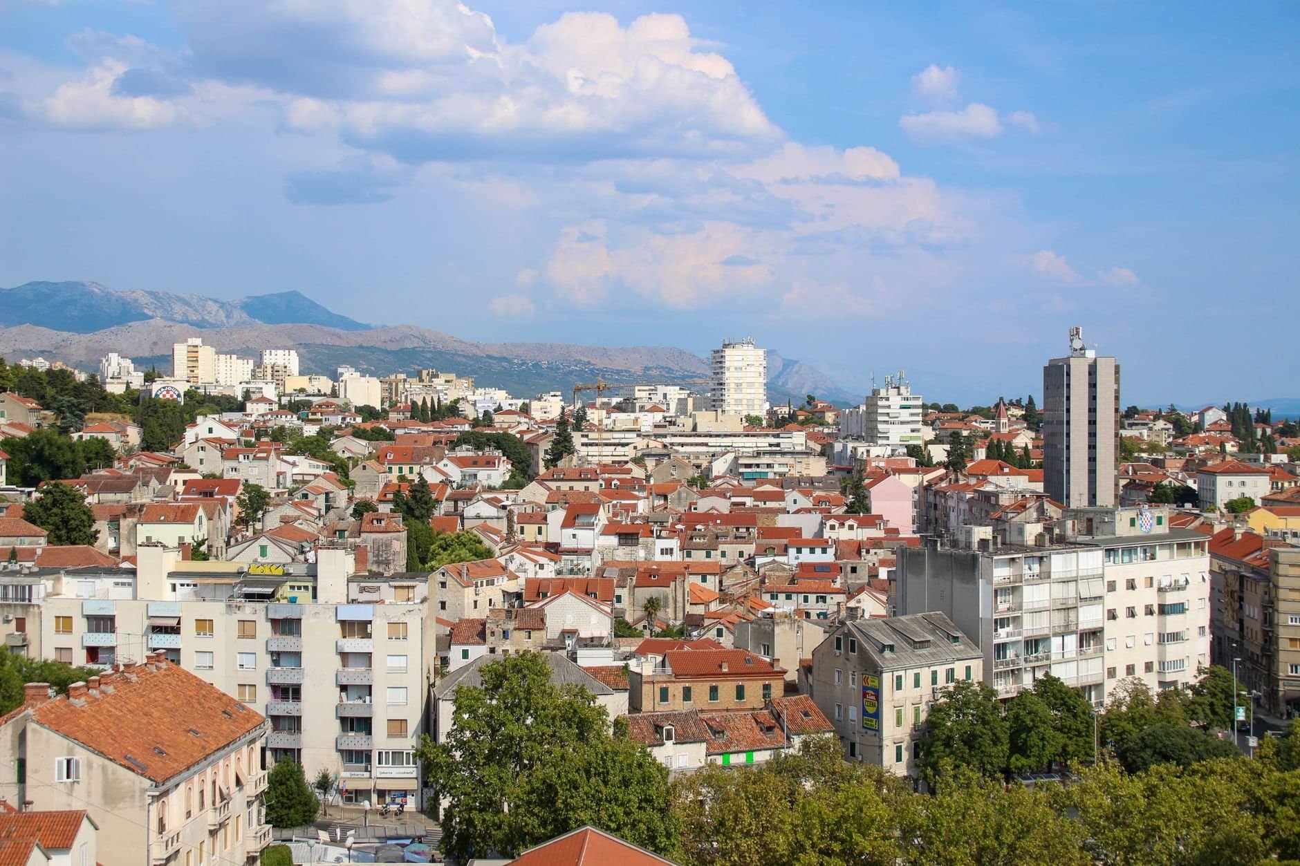 Aerial panoramic view of Split, Croatia showcasing urban architecture and distant mountains.