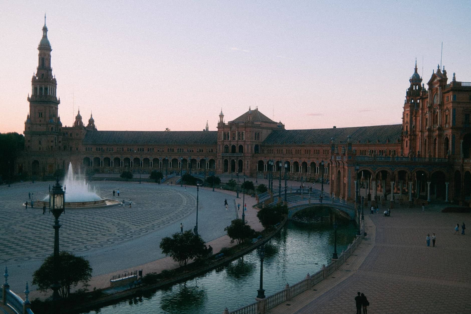Capture of the iconic Plaza de España at twilight in Seville, showcasing its beautiful architecture and serene atmosphere.