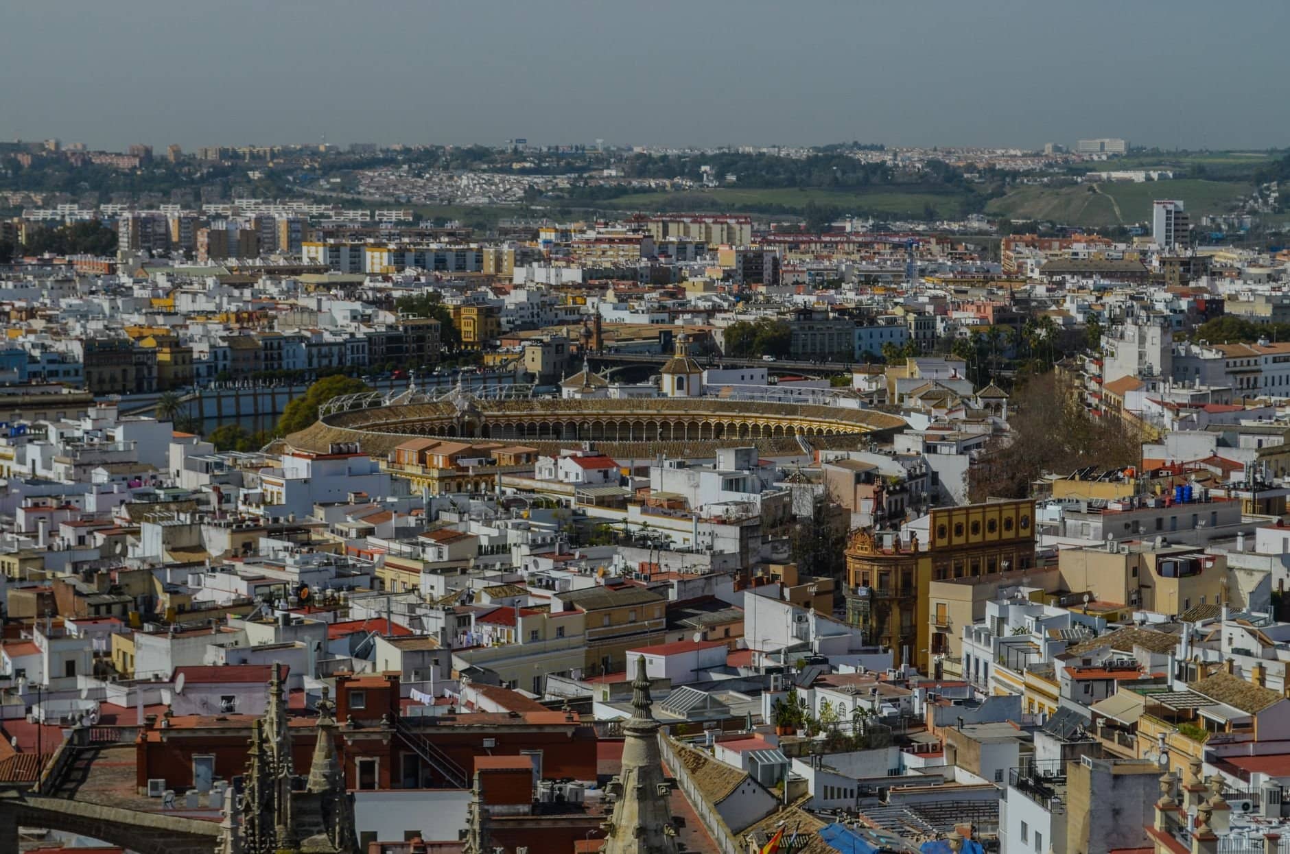A stunning aerial view of Seville showcasing the iconic bullring and surrounding historic architecture.