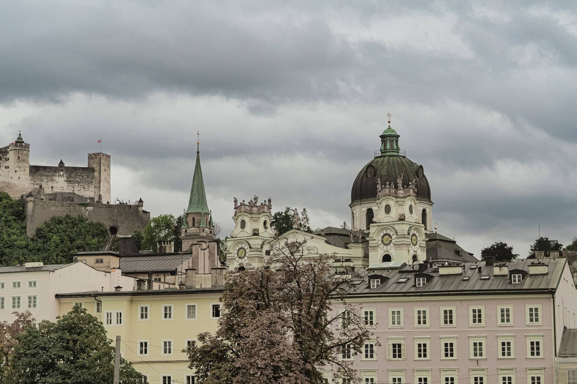 Explore the architectural charm of Salzburg's Dom Quartier with Hohensalzburg Fortress in the backdrop.