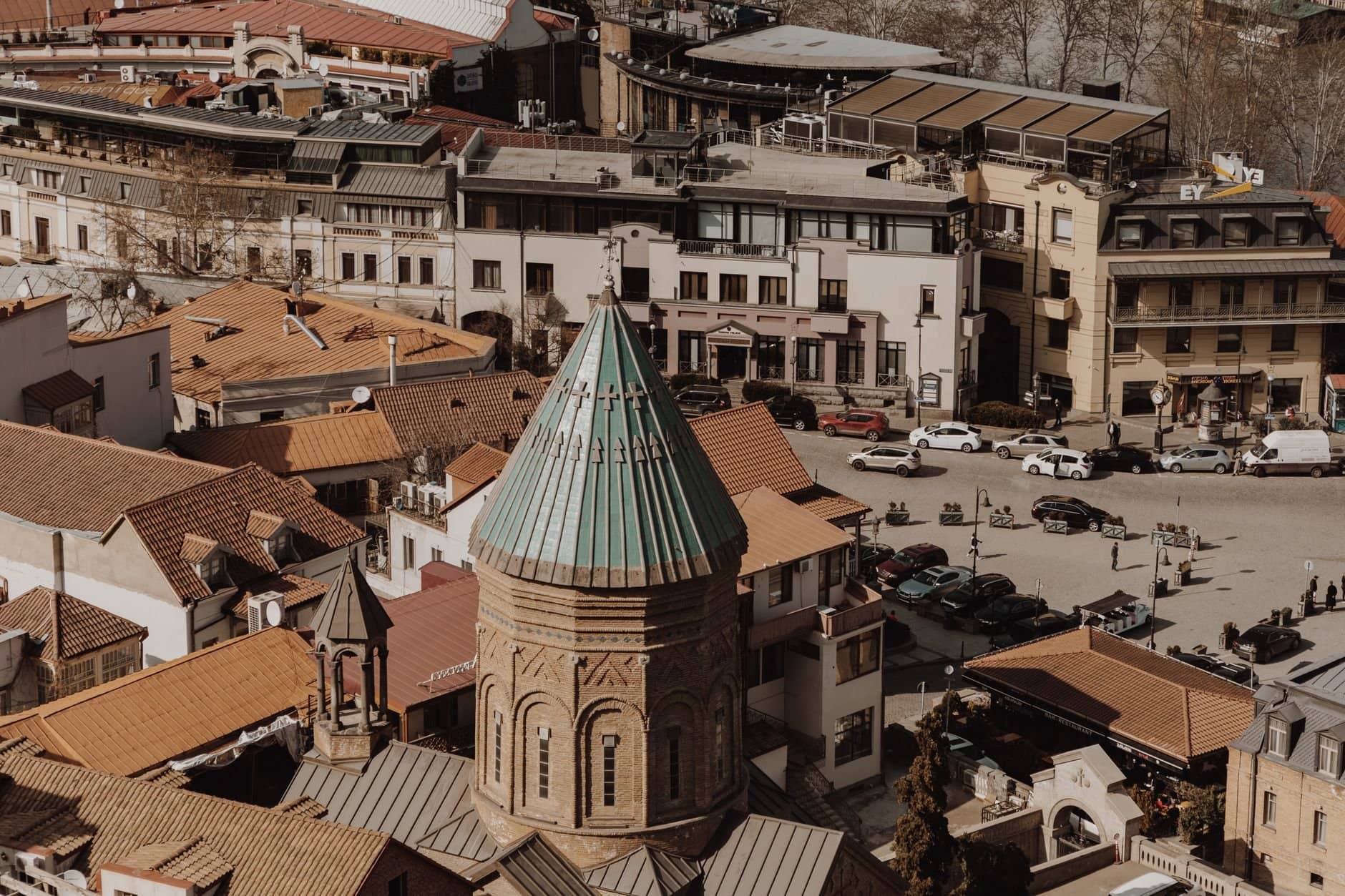 Aerial view of old town Tbilisi showcasing historic architecture and city life.