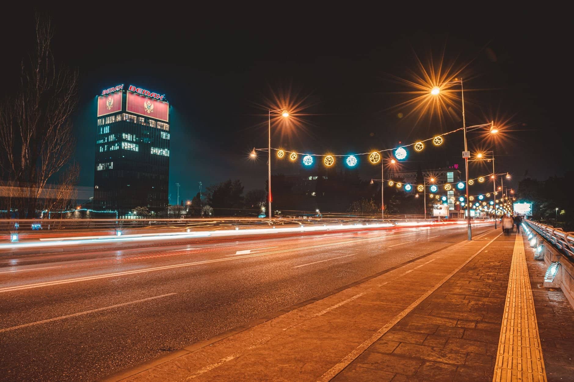 Vibrant night scene showing light trails on a street in Podgorica, Montenegro.