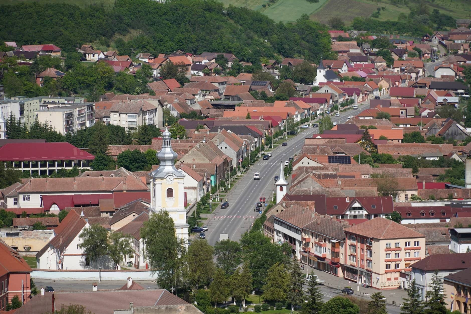 Aerial view of Rupea town in Transylvania, Romania, showcasing traditional architecture and scenic landscapes.