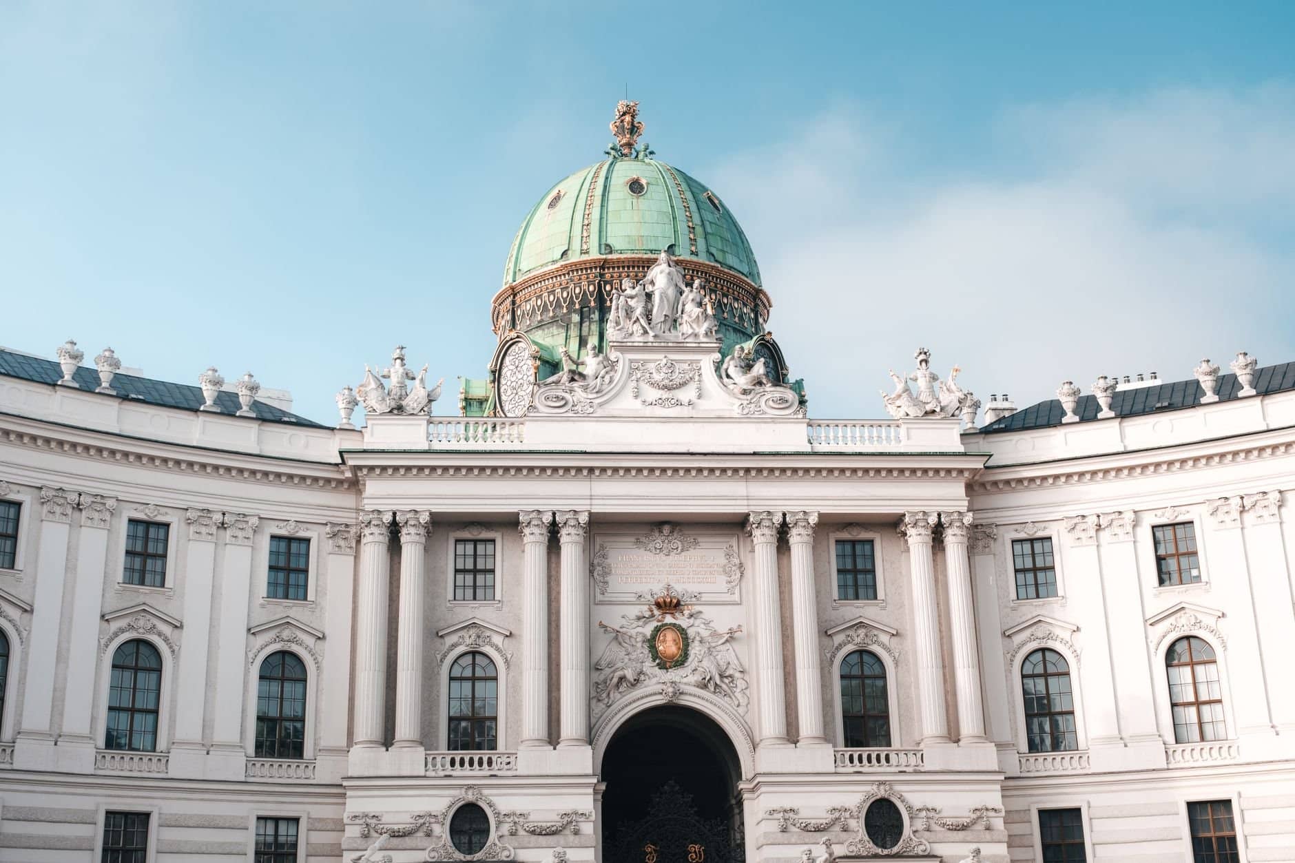 Elegant view of the Hofburg Palace's dome and facade in Vienna, Austria under a clear sky.