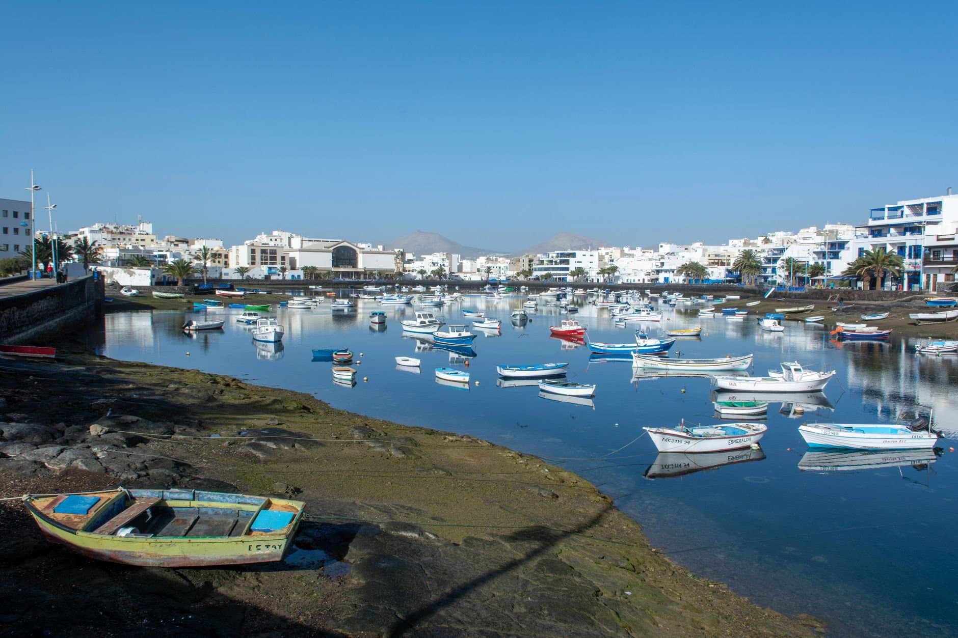 A tranquil shot of boats in Arrecife marina under a clear blue sky.
