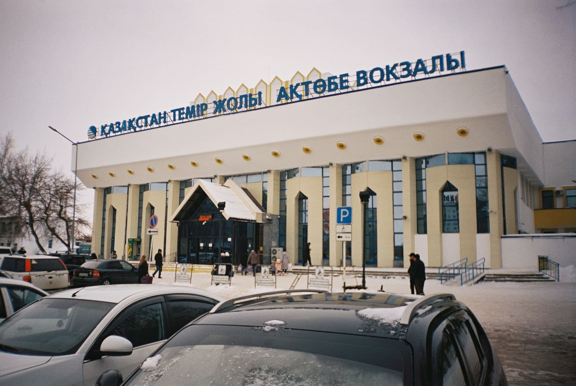 A snowy day at Aktobe Railway Station, showcasing urban winter life in Kazakhstan.