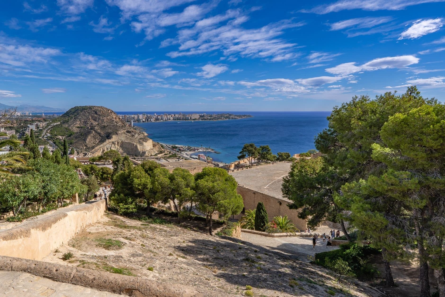 Stunning ocean and cityscape view from Alicante, Spain under a bright blue sky.
