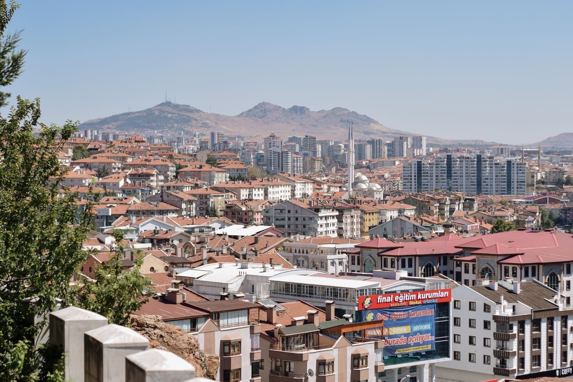Discover Ankara's vibrant cityscape with diverse residential architecture and hill backdrop.