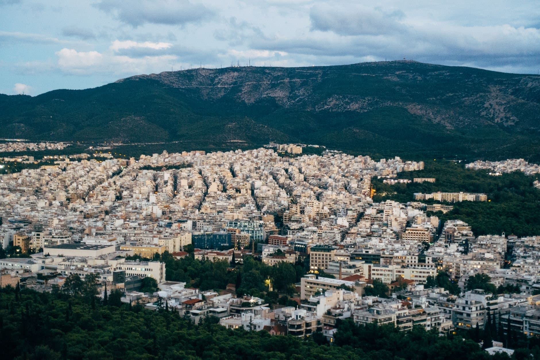 A stunning aerial view of Athens, Greece, showcasing dense urban architecture and surrounding landscapes.