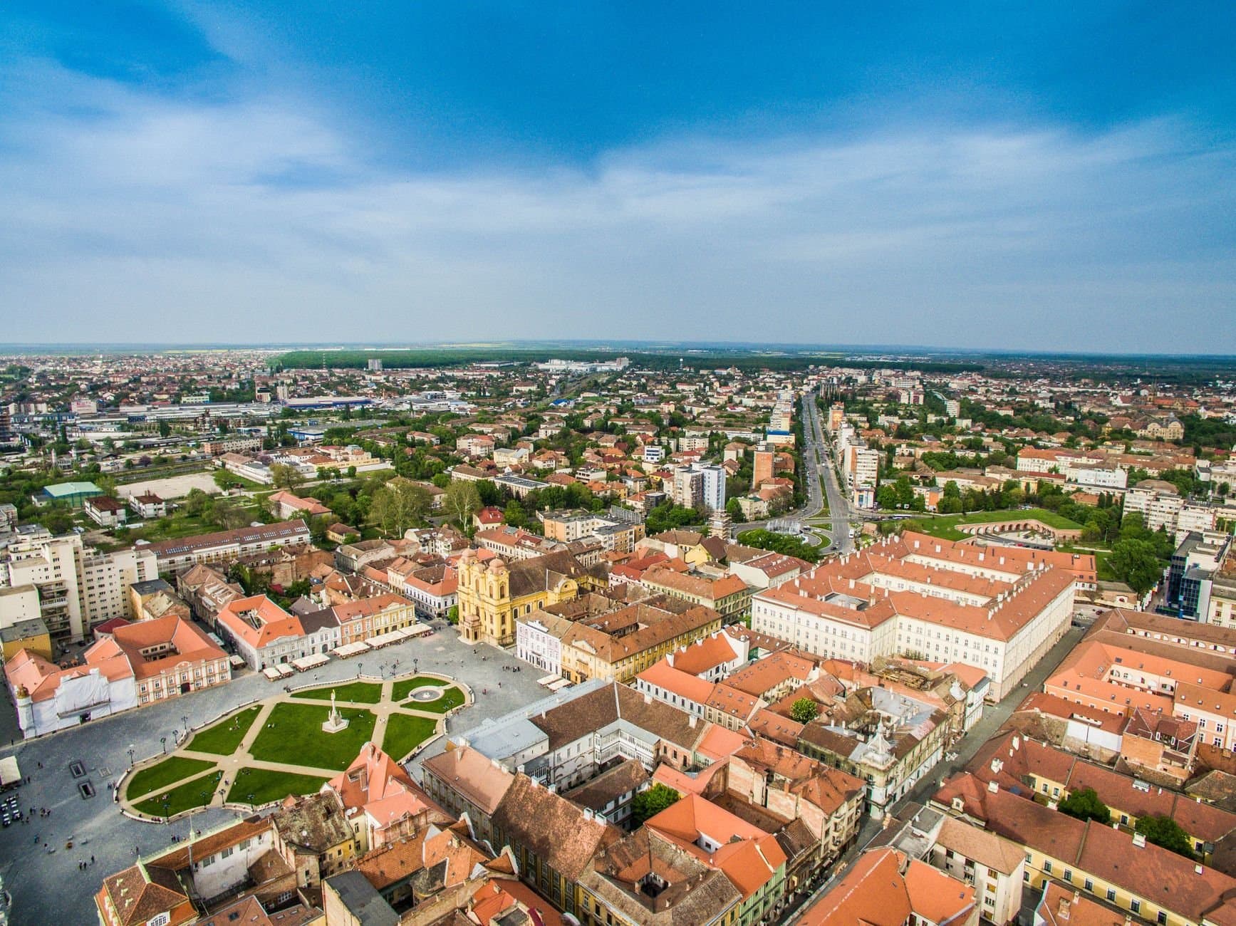 Drone shot of Timișoara's vibrant cityscape showcasing historic architecture and urban layout.