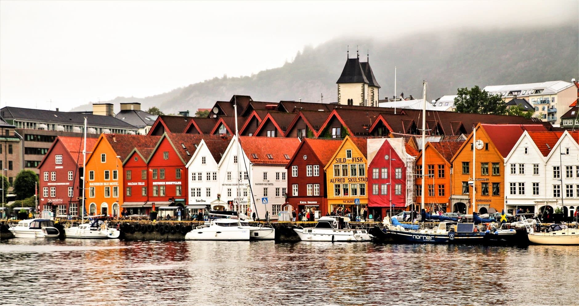 Charming waterfront of Bergen showcasing vibrant historic buildings and boats.