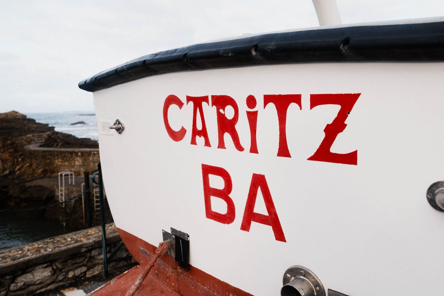 Close-up of a boat stern at Biarritz harbor in France, showcasing nautical elements.