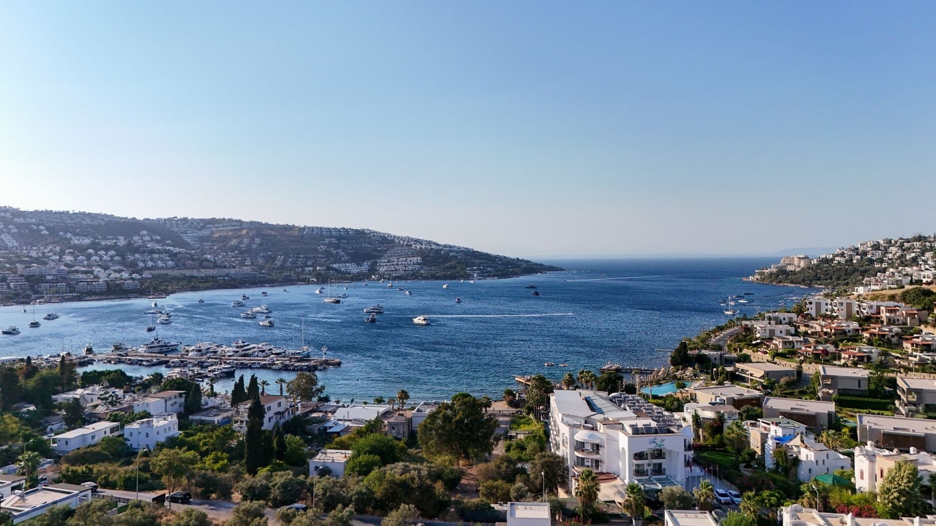 Aerial view of a beautiful coastal town in Bodrum, Turkey with boats in the harbor.