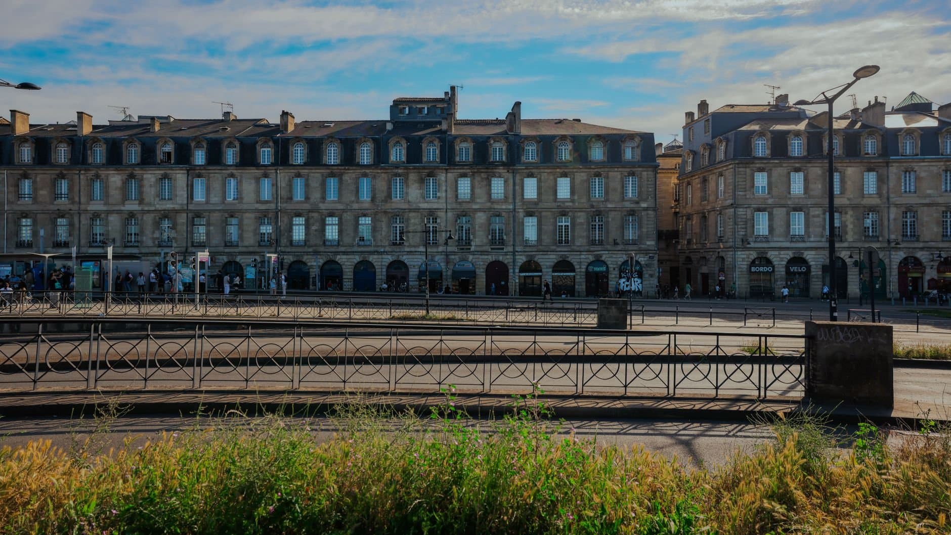 Elegant historic buildings in Bordeaux, France under a clear blue sky.