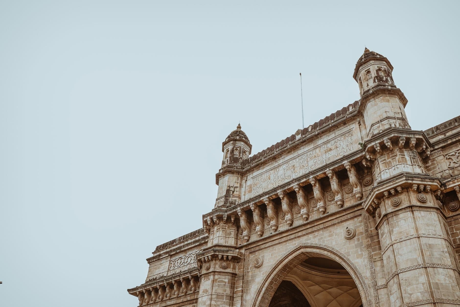 Low-angle view of the Gateway of India showcasing intricate architectural design in Mumbai.