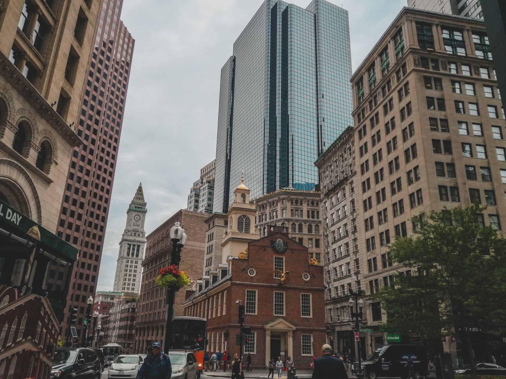 Dynamic urban scene showcasing Boston's Old State House against modern skyscrapers.