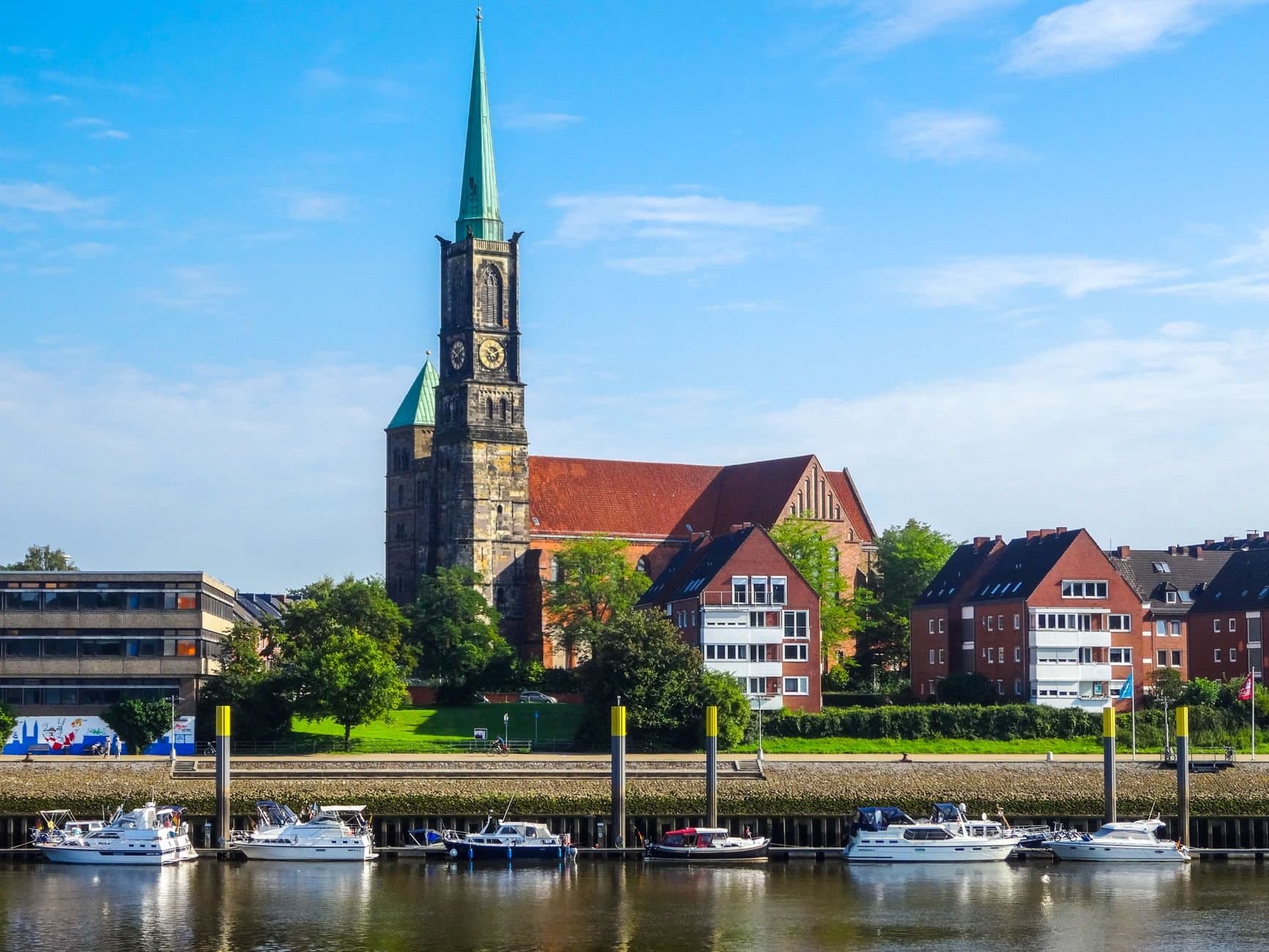 View of St. Stephani Church and the scenic Weser River waterfront in Bremen, Germany.
