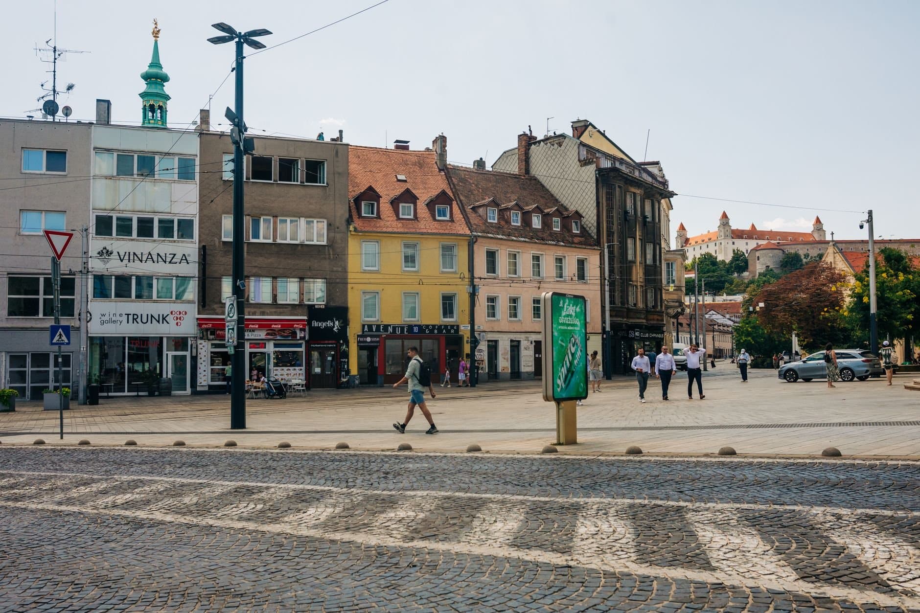 A vibrant day in Bratislava city center, showcasing historic architecture and street life.