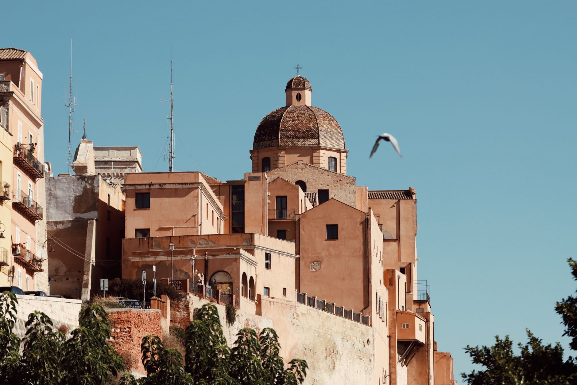 View of the architectural dome in Cagliari, Sardinia with clear blue sky.