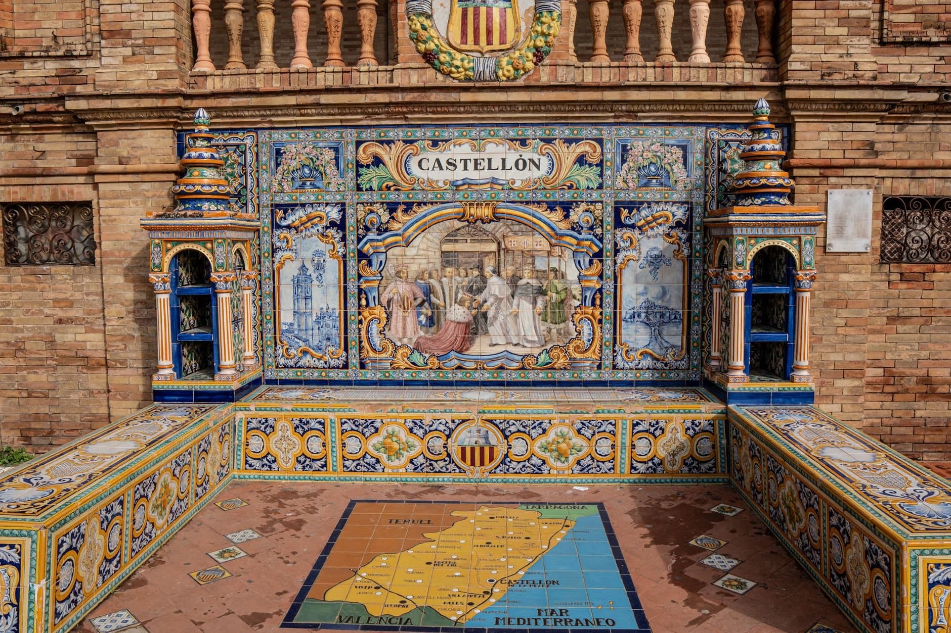 Vibrant ceramic tiles depicting Castellón at Plaza de España in Seville, Spain.