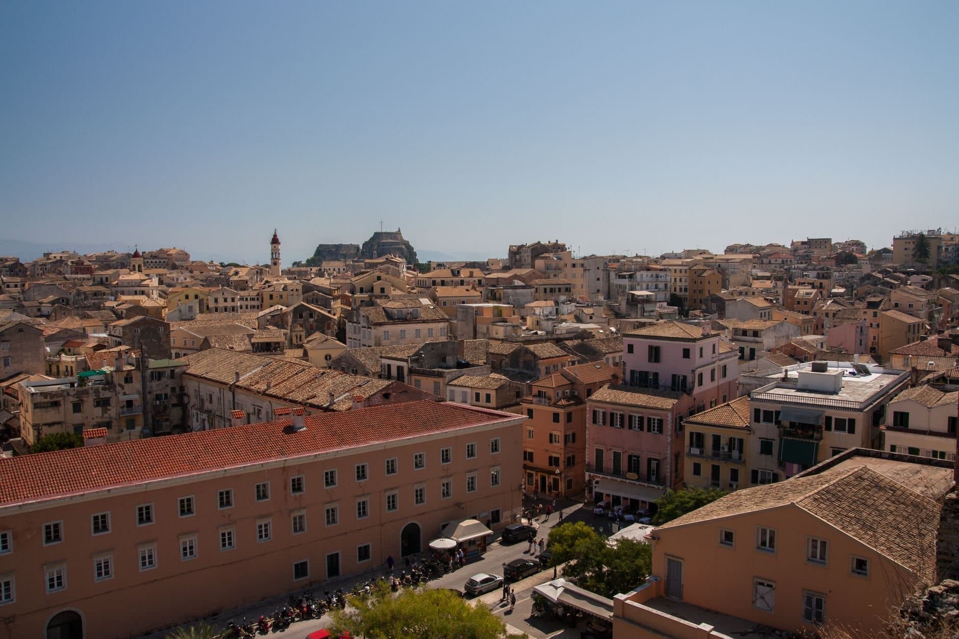 Aerial view of the historic Old Town of Corfu, Greece with its charming architecture under a clear blue sky.