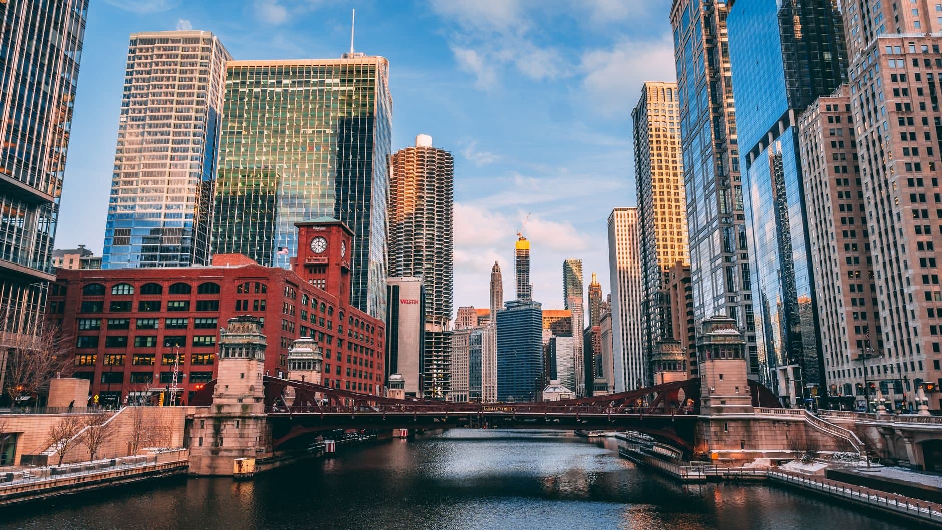 Stunning view of Chicago's skyline reflecting on the river during sunset.