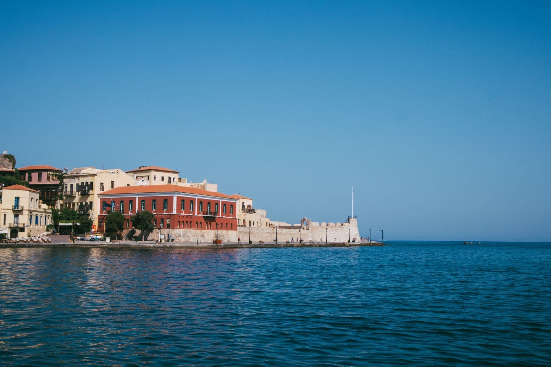 Picturesque waterfront view of Chania town in Crete, Greece with clear blue skies.