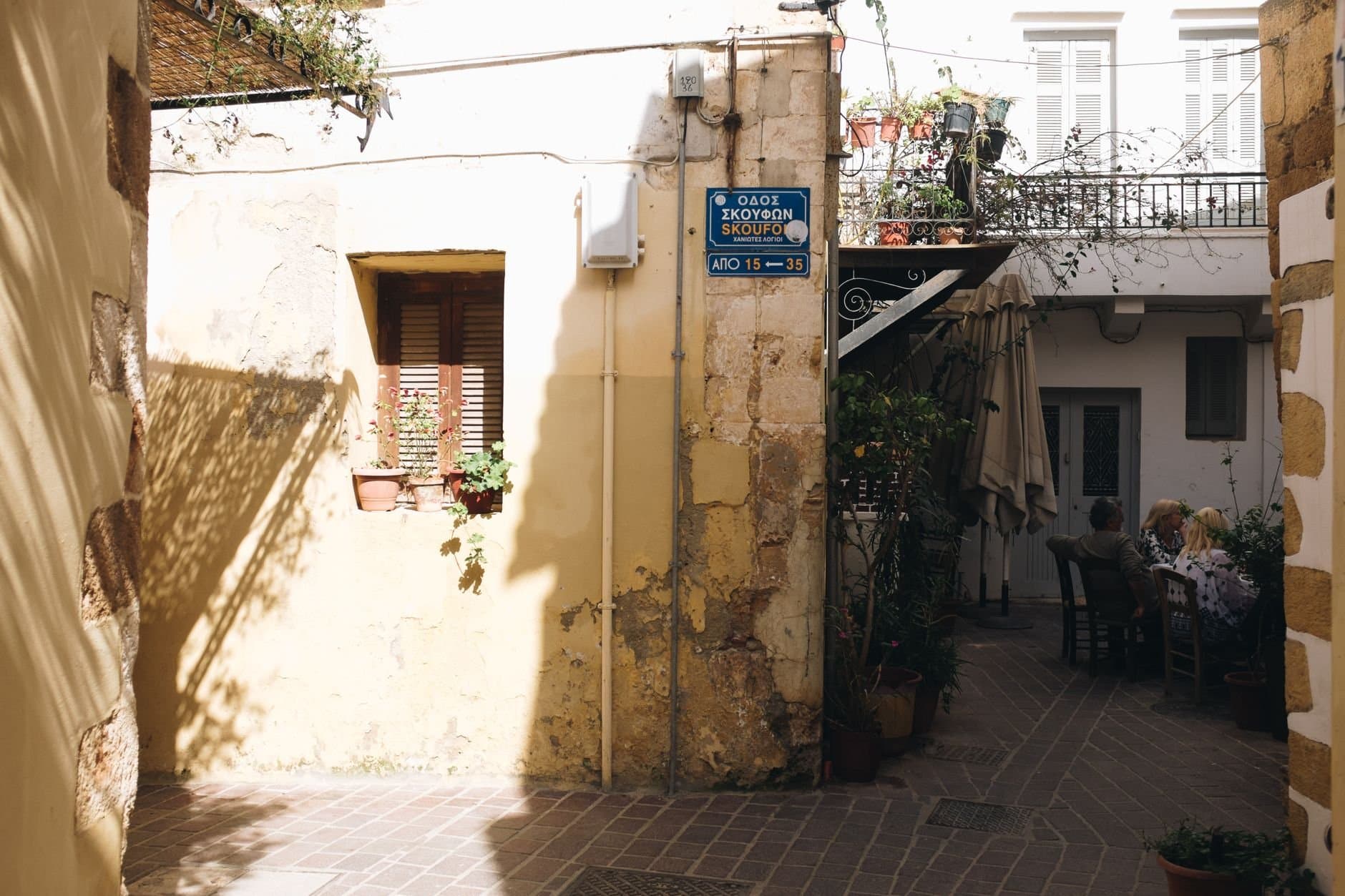 Cozy Mediterranean alley in Chania with rustic architecture and relaxed atmosphere.