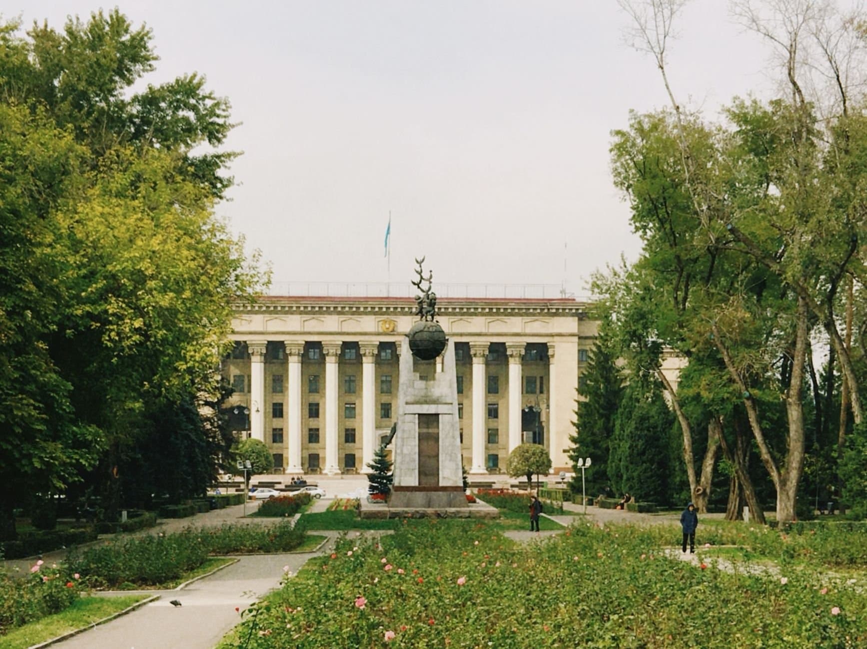 Monument in front of a significant historical building in Almaty, Kazakhstan.