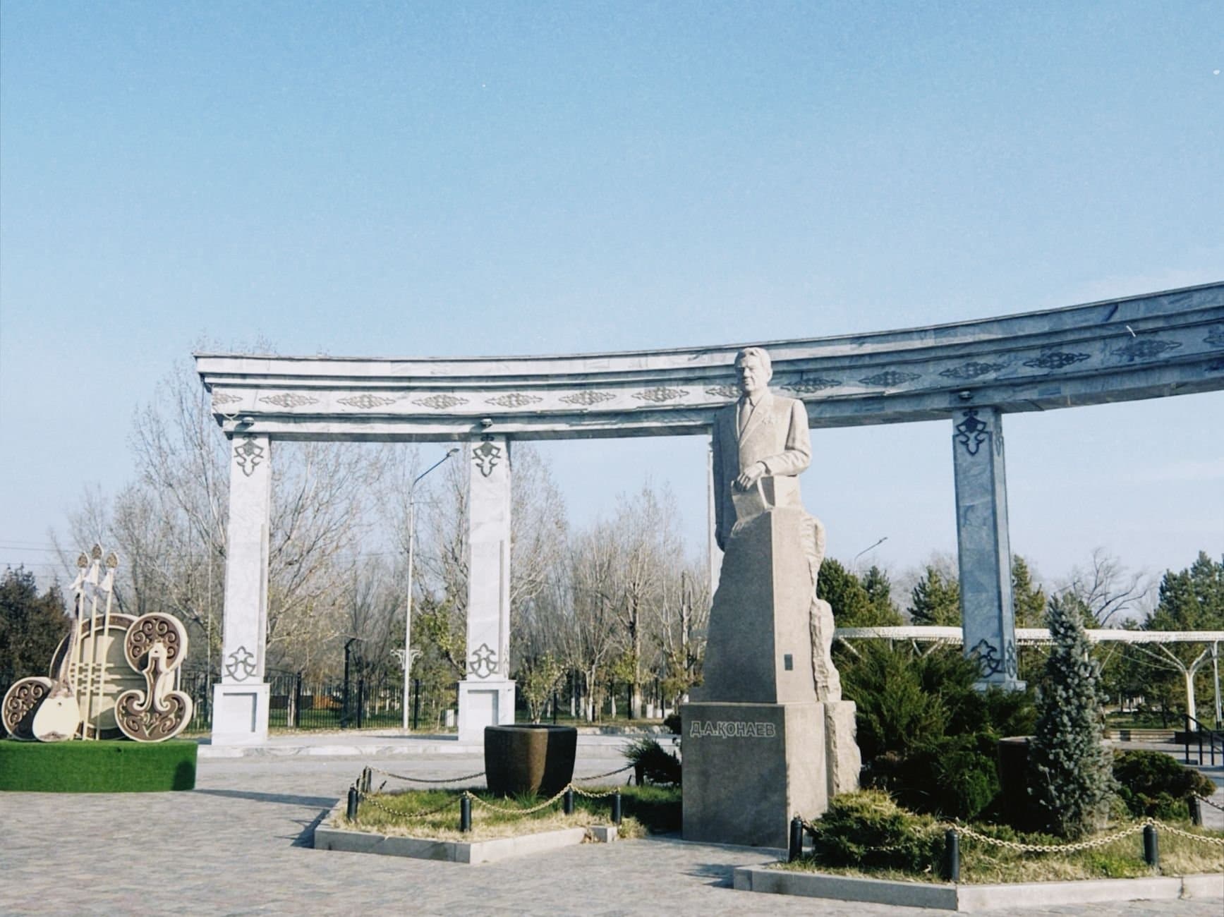 Statue surrounded by architectural arch in Konaev, Almaty Region, Kazakhstan.