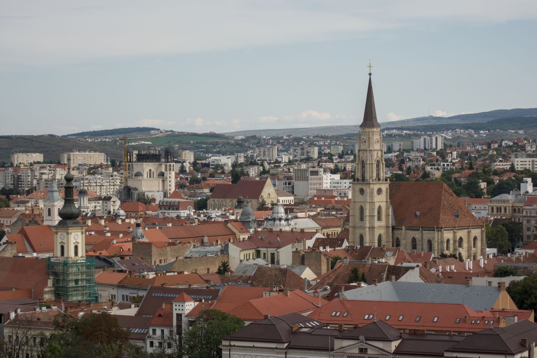 Aerial view of Cluj-Napoca showcasing churches and cityscape.