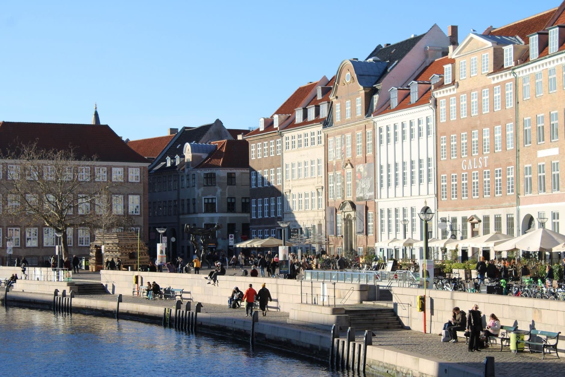 A sunny winter day along Copenhagen's waterfront, showcasing historic architecture.