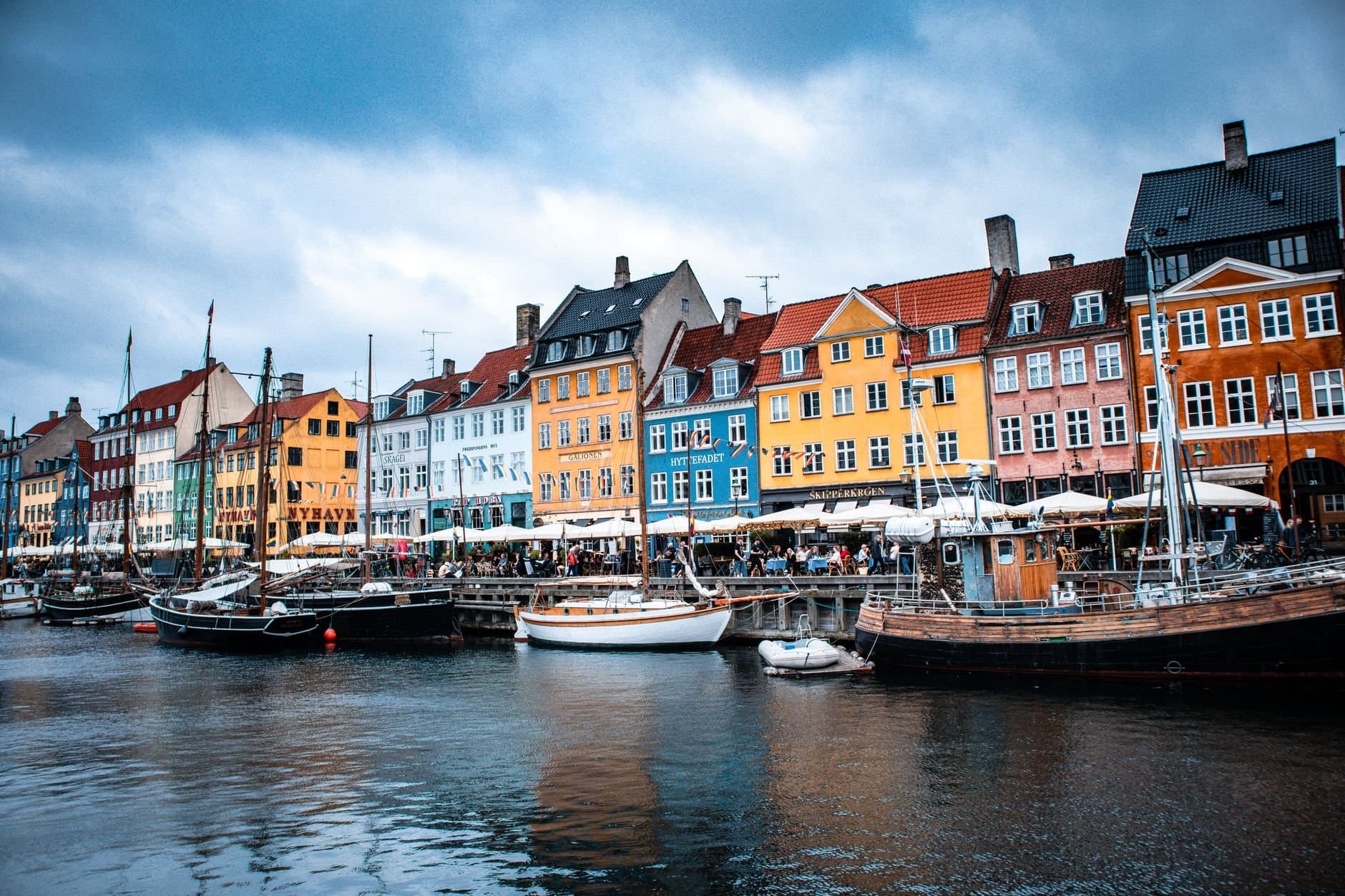 Vibrant boats and colorful buildings at Nyhavn harbor, Copenhagen's iconic waterfront.