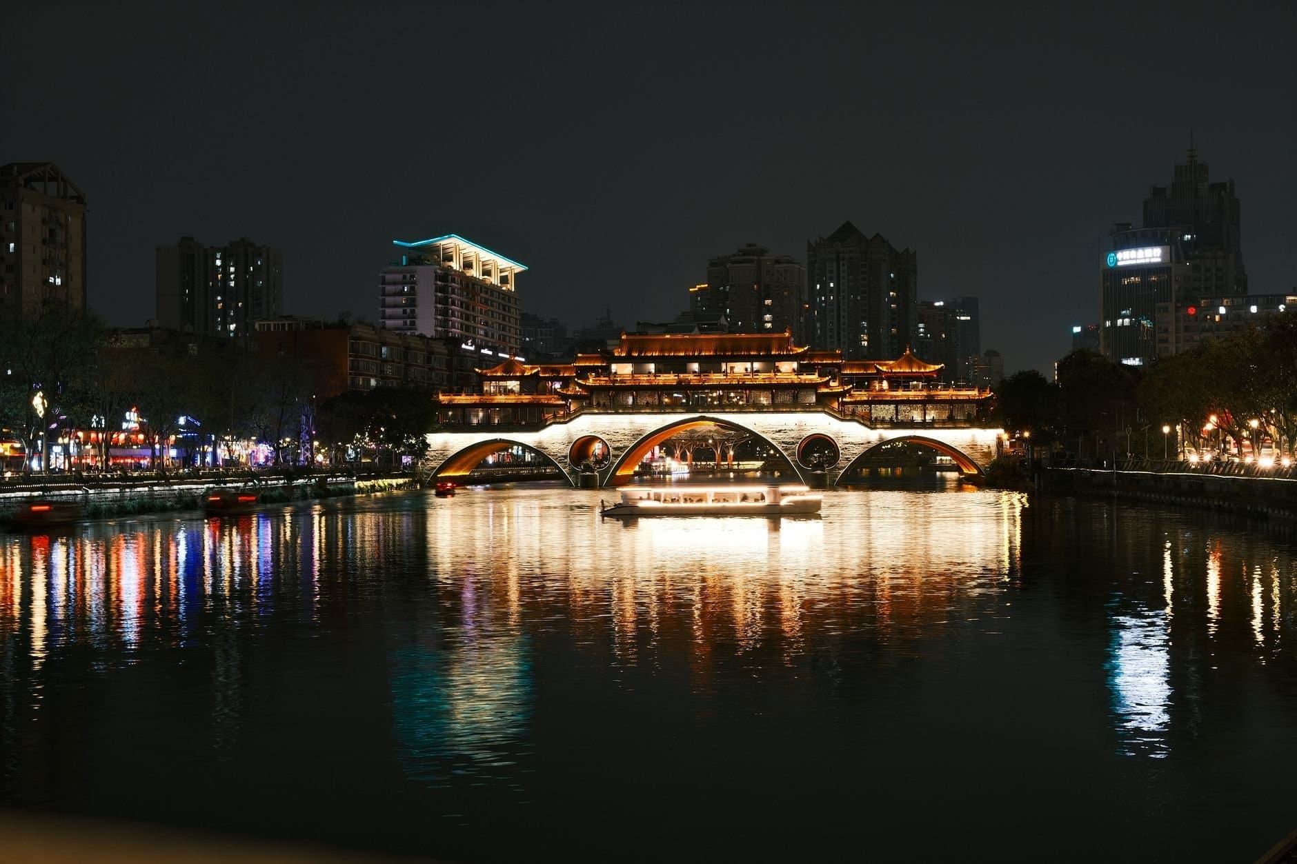 Stunning night scene of the illuminated Anshun Bridge and its reflection in Chengdu, China.
