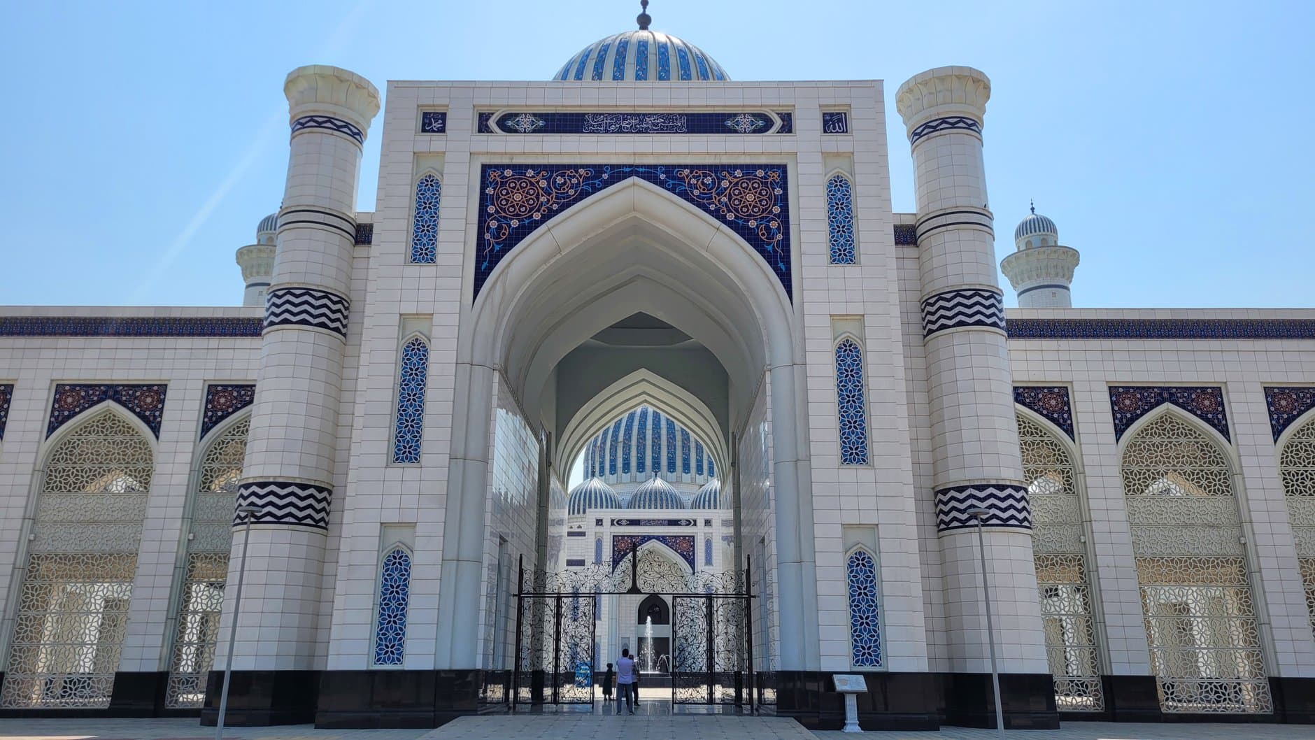 Elegant entrance of a famous mosque in Dushanbe, featuring intricate mosaic designs.