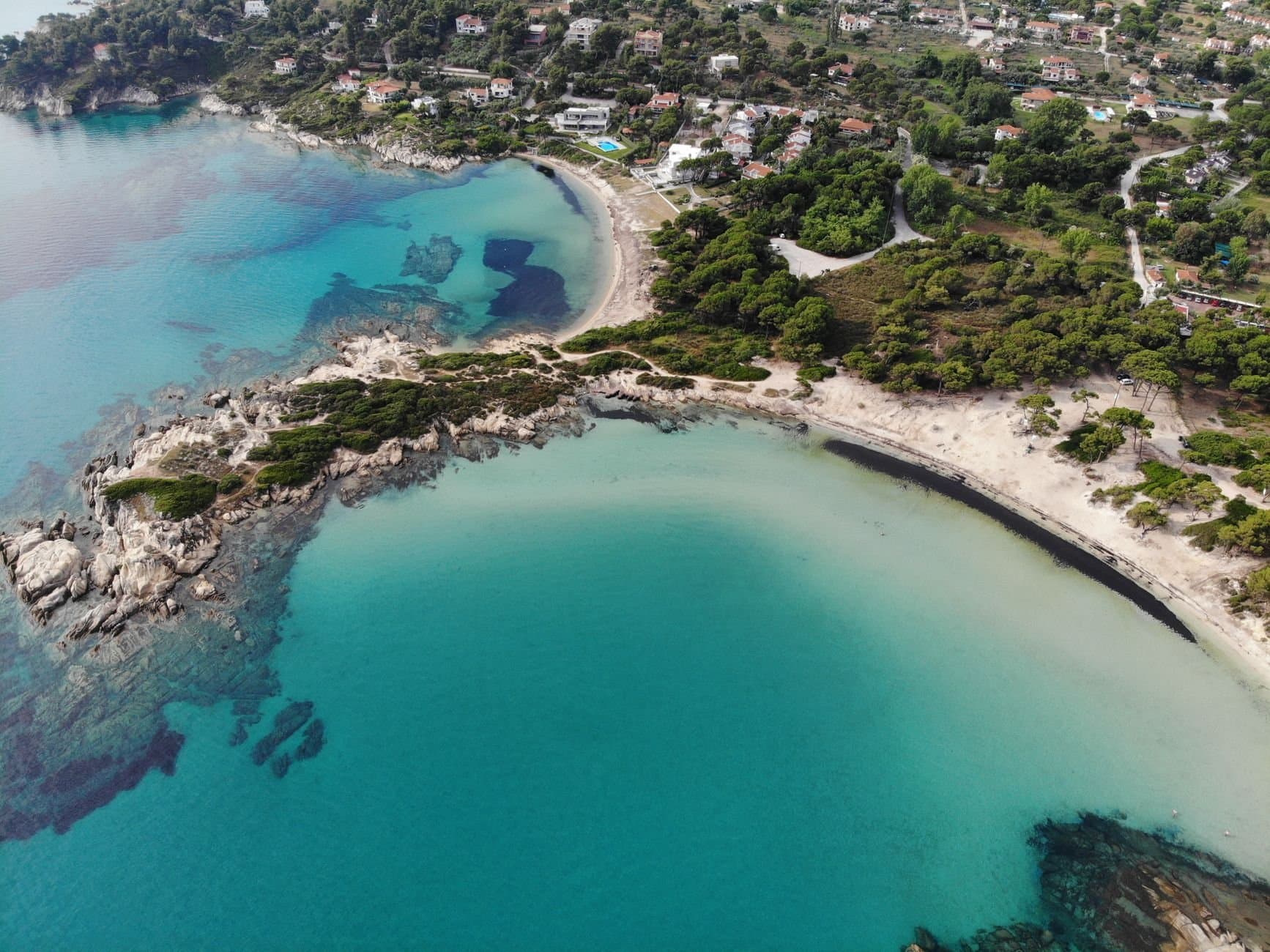 Discover the stunning beaches and vibrant sea of Sithonia, Halkidiki, Greece from above.