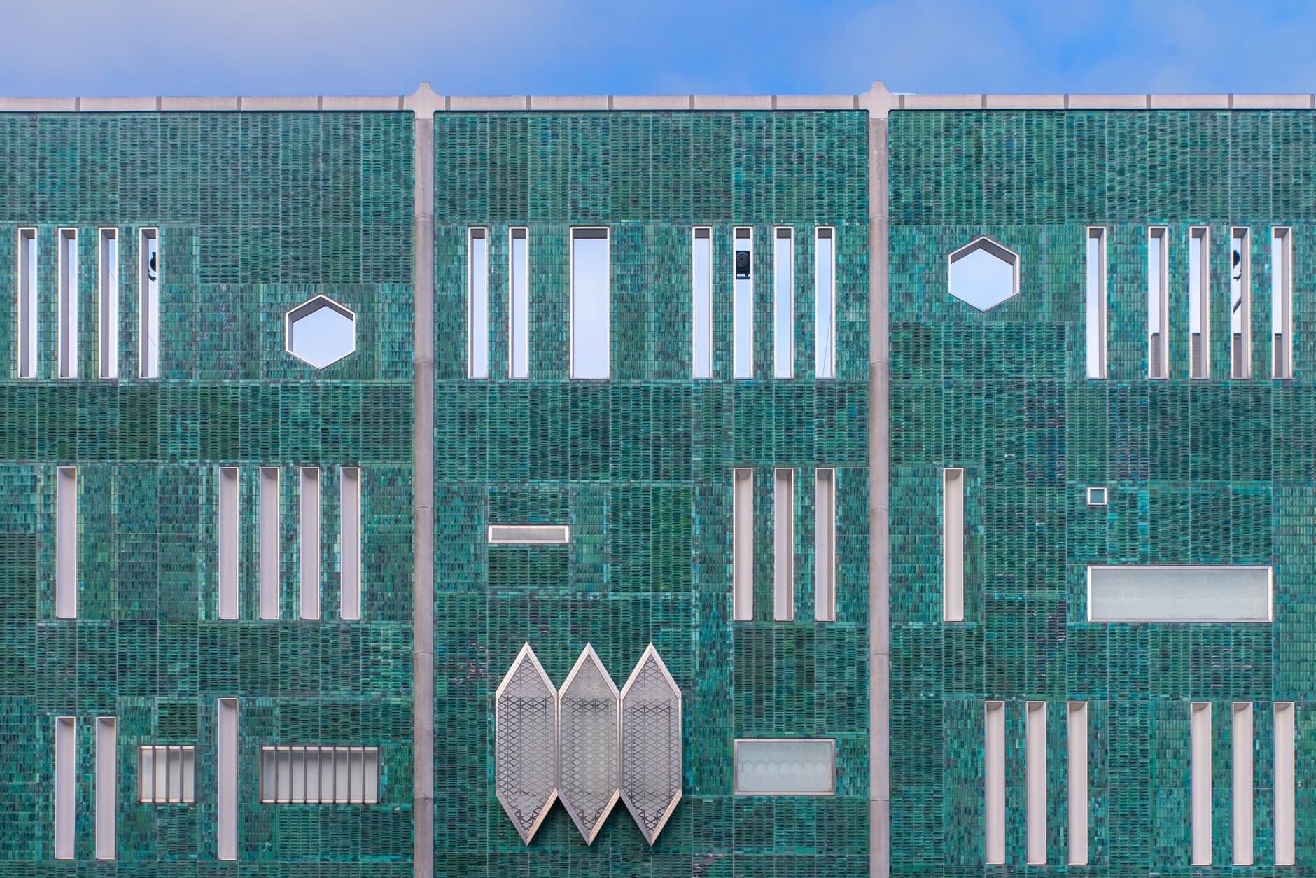 A striking green geometric building facade in Eindhoven, Netherlands.