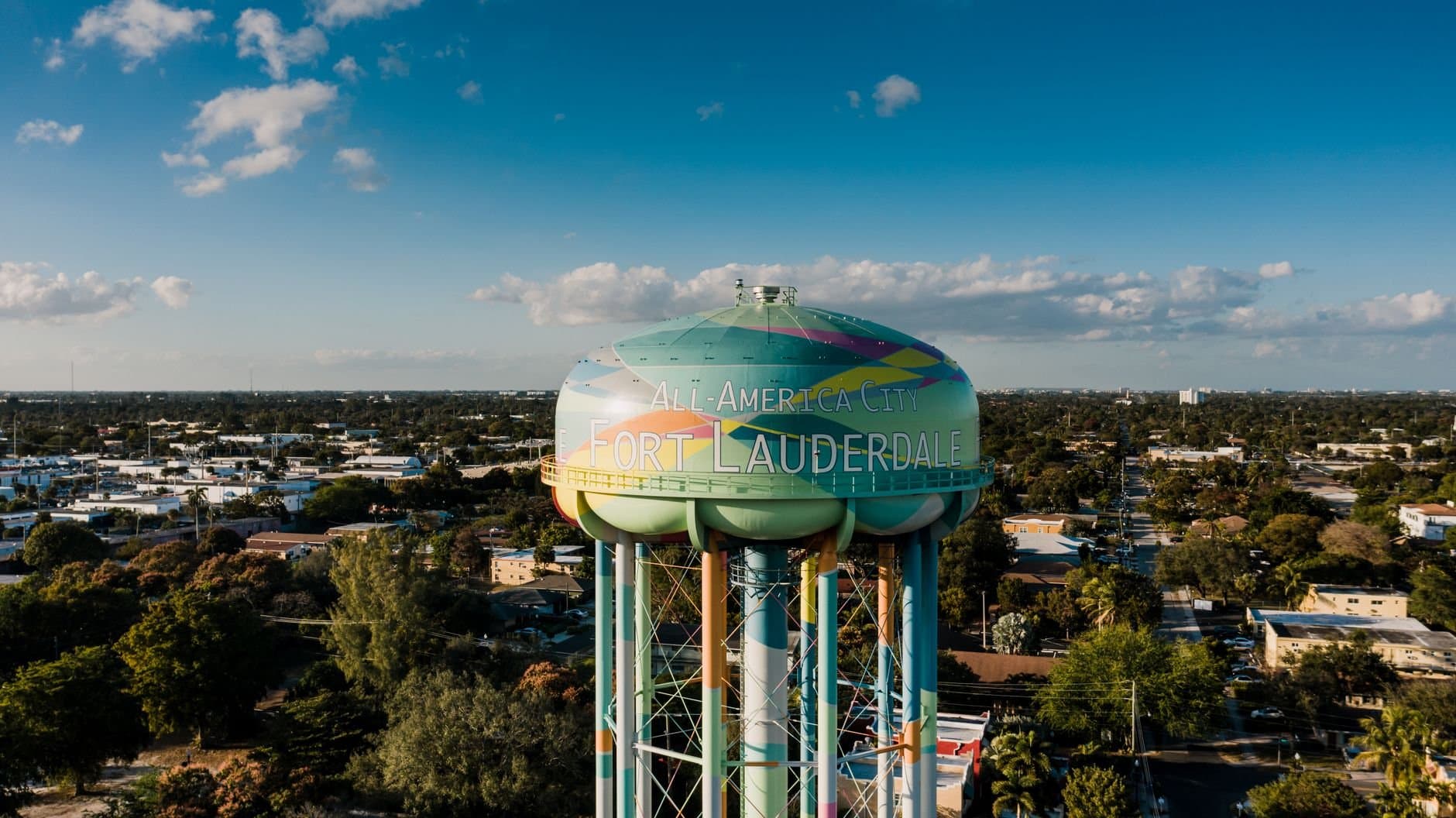 Picturesque drone view of colorful elevated water tower located against cloudy blue sky in Fort Lauderdale