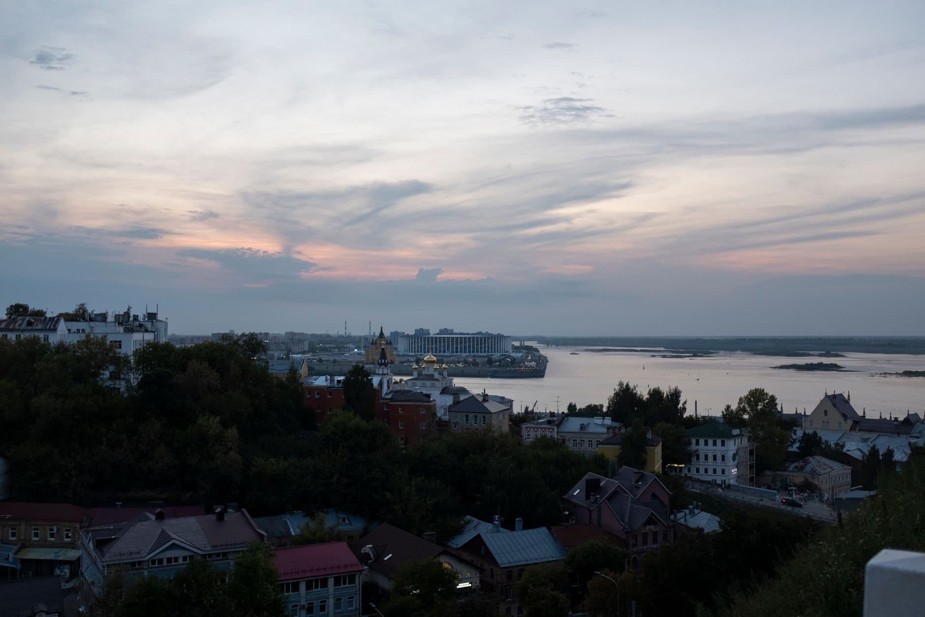 Dusk over Nizhny Novgorod, Russia featuring a panoramic view of the cityscape along the Volga River.