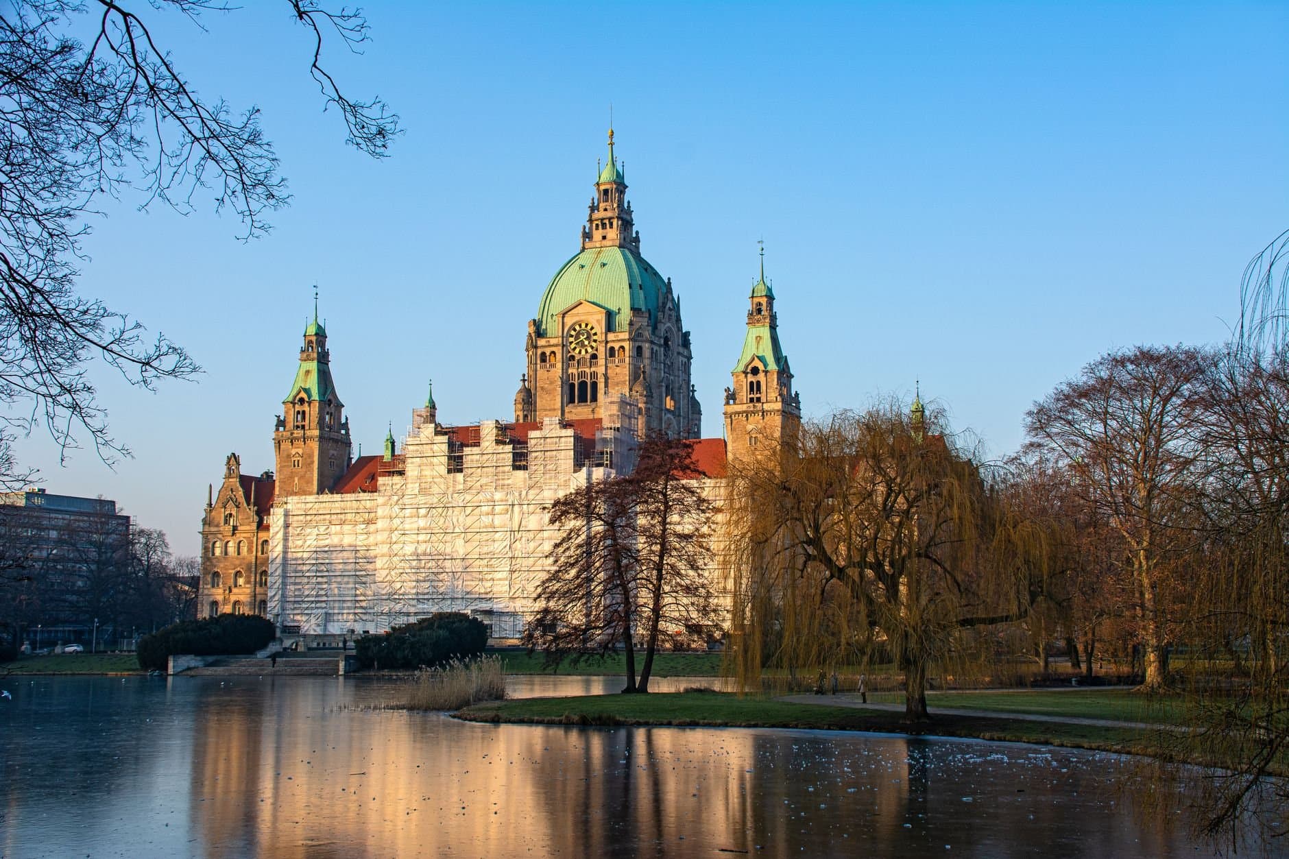 Stunning view of the Hanover New Town Hall during winter with clear blue sky.