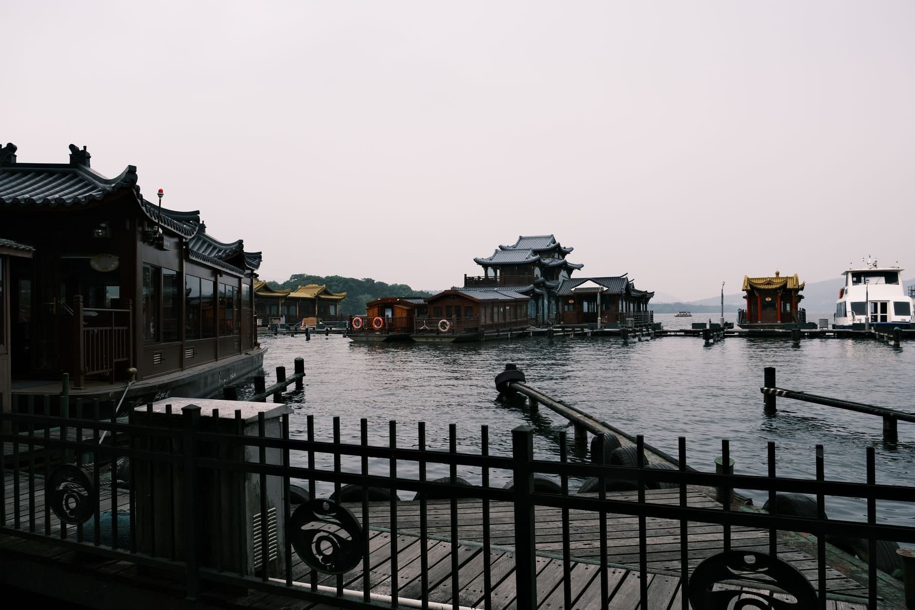Serene view of traditional floating pagodas on West Lake, Hangzhou, China, capturing cultural architecture.