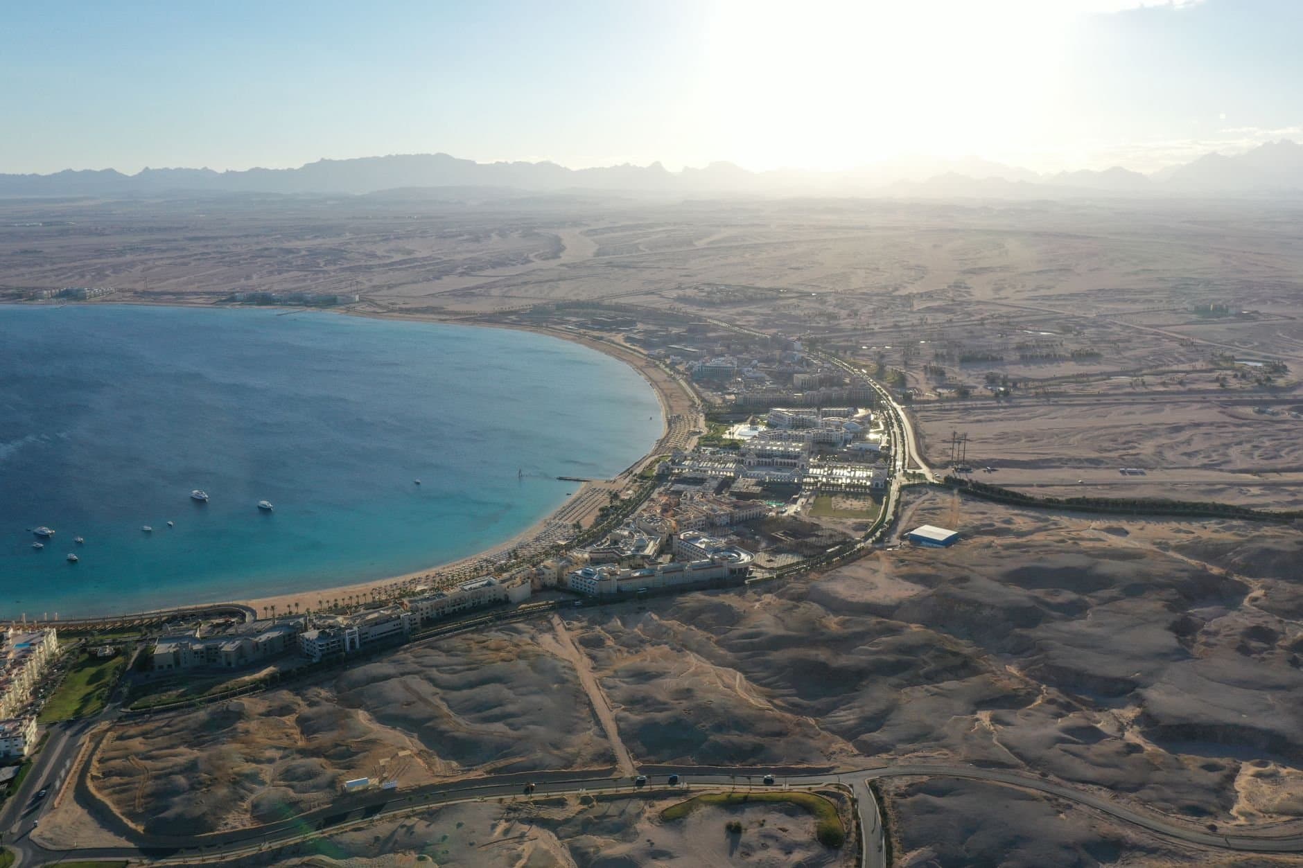 Stunning drone shot of Hurghada's coastline and desert panorama during sunset.