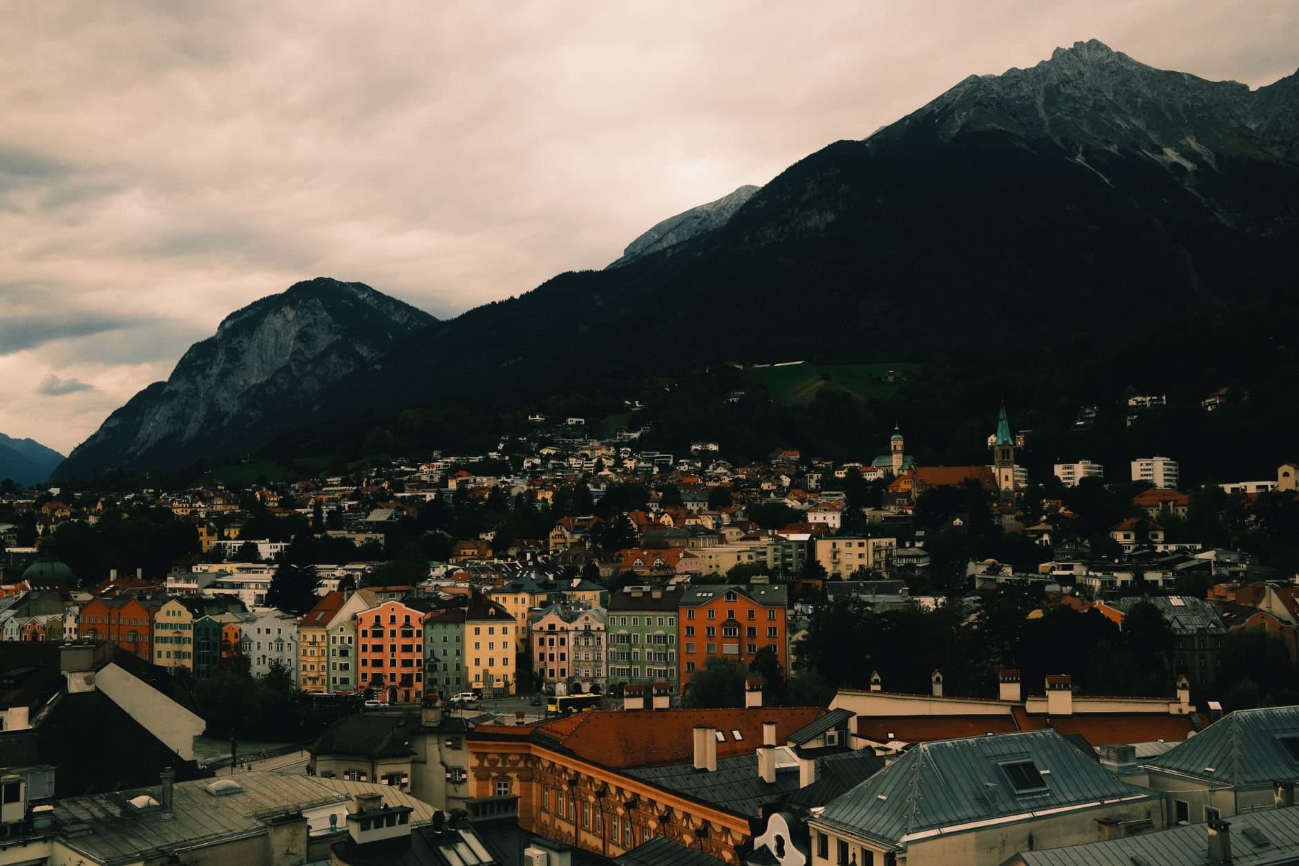 Beautiful panoramic view of Innsbruck, Austria, showcasing colorful architecture against a stunning mountain landscape.